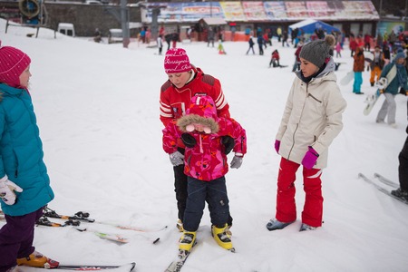 Ukraine, Kiev ski resort Protasov Yar January 25, 2015. The ski slope in the city center. Ski school for children. The instructor teaches a group of people in the winter to snow a mountain to ski.のeditorial素材