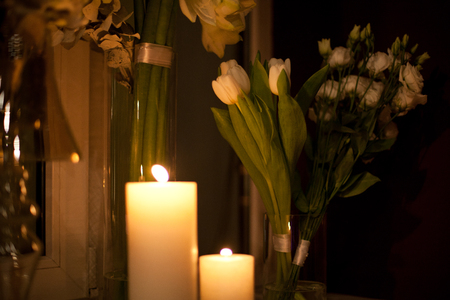 white candle in glass, red roses, romance is in the interiorの写真素材