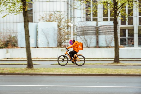 October 25, 2018 Germany is the city of Dusseldorf. Bicycle as an ecological transport, means movement in Europe. A city dweller rides a bike on the way.のeditorial素材