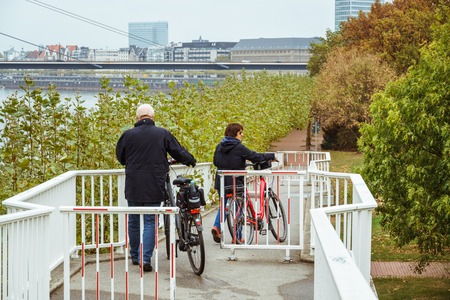 October 25, 2018 Germany is the city of Dusseldorf. Bicycle as an ecological transport, means movement in Europe. A city dweller rides a bike on the way.のeditorial素材