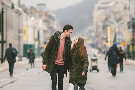 young couple, heterosexual boy and girl of Caucasian nationality, loving couple, walk around the center of country of European city in the middle of road on divided lane. Love and Romance Theme.の写真素材