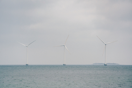 The theme is net power generation and environmental protection. A number of wind blades, wind power in the Baltic Sea in Europe Denmark Copenhagen in winter.の写真素材