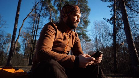 theme hiking nature travel. Caucasian male tourist with beard and backpack resting, break turned...