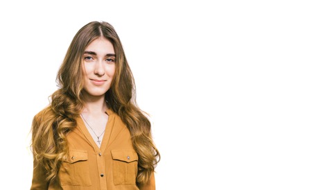 Portrait of a beautiful young woman with long curly hair on a plain white background. The theme is...