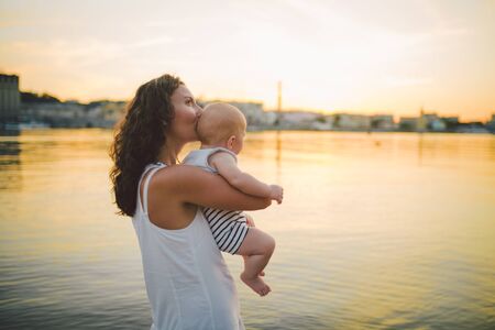 Family and Single mom concept, women carrying sonr and kiss. Concept of happy family. Close Up....