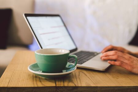 Closeup business woman hands using laptop with cup coffee. Woman Hands Typing keyboard computer In...