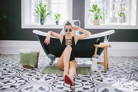 Theme fashion and style. Holiday rich women in spa expensive hotel. Caucasian young sexy girl sits...