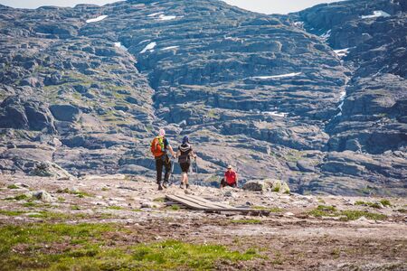 July 26, 2019. Norway tourist route on the trolltunga. People tourists go hiking in the mountains of Norway in fine sunny weather to thetrolltunga. Hiking backpack theme.のeditorial素材
