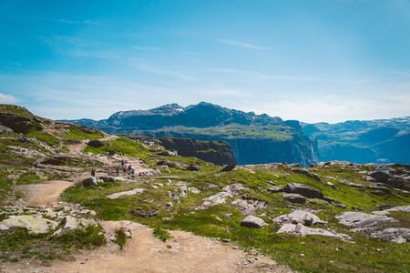 July 26, 2019. Norway tourist route on the trolltunga. People tourists go hiking in the mountains of...