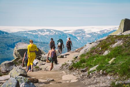 July 26, 2019. Norway tourist route on the trolltunga. People tourists go hiking in the mountains of Norway in fine sunny weather to thetrolltunga. Hiking backpack theme.のeditorial素材