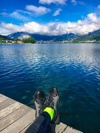 Feet Selfie Traveler relaxing with lake and mountains view on background Lifestyle hiking Travel...