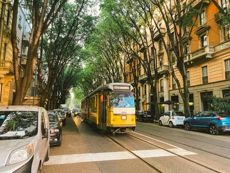 September 25, 2019 Italy. Milan. The yellow retro old tram of Milan in mint condition, still operates. Famous vintage tram in the centre of the Old Town of Milan.のeditorial素材