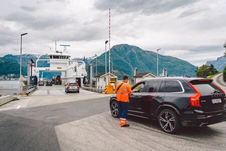 July 22, 2019 Norway. Vangsnes. Cars loading on the ferry in the port, Norway. View on interior of empty ferry waiting in harbour to be loaded with cars. Personal cars onboard a cargo ferryのeditorial素材