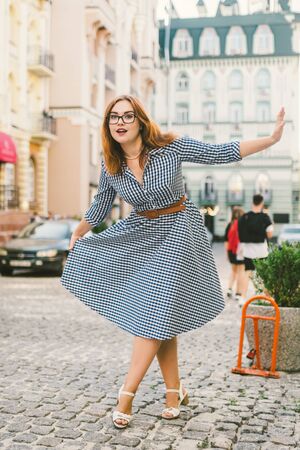 happy stylish woman at old european city street, moment of carefree and true happiness. Young beautiful cheerful woman walking on old street. European trip, old city, summer vacation.の写真素材