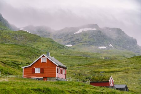 hut wooden mountain huts in mountain pass Norway. Norwegian landscape with typical scandinavian...