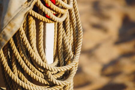 Rope On Boat's Deck. Hanging rope wool close-up on blurred background.