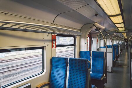 Inside The Wagon Train Germany, Dusseldorf. Empty train interior. interior view of corridor inside passenger trains with blue fabric seats of German railway train system.の写真素材
