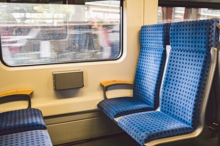 Inside The Wagon Train Germany, Dusseldorf. Empty train interior. interior view of corridor inside passenger trains with blue fabric seats of German railway train system.の写真素材