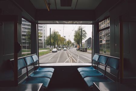 high-speed tram on the city street. Modern Tram In Dusseldorf, Germany October 20, 2018. Tram inside view, passenger compartment with passengers during a ride in Germany.のeditorial素材