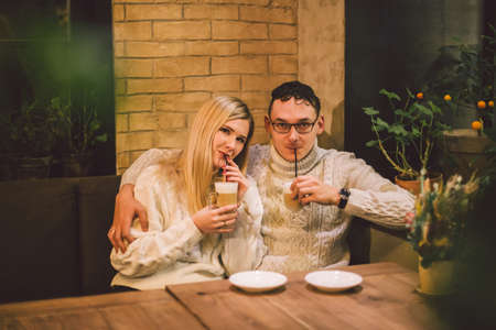 Beautiful couple having coffee on a date,having fun together. Couple young people drinking coffee in...