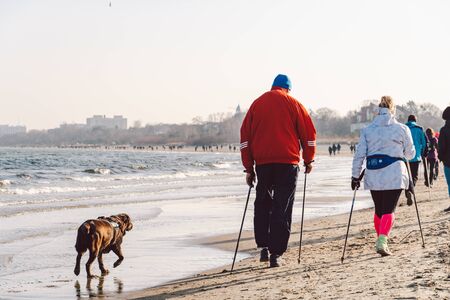 Poland, Sopot, February 9, 2020. People at beach in Sopot. Crowd on Beach During Winter. enjoying...