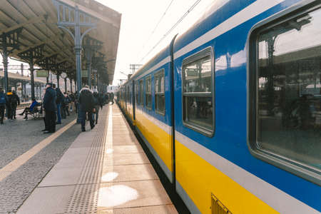 Regional new blue yellow train arriving to gdansk glowny railway station in Poland, Gdansk February 9, 2020. SKM regional railway in poland. View of regional railway carriage on platform.のeditorial素材
