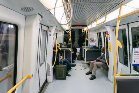 Interior view of a Copenhagen driverless metro train with passengers. Theme city passenger transport in Copenhagen. Subway in Denmark Copenhagen, February 18, 2019. People in the modern European metroのeditorial素材