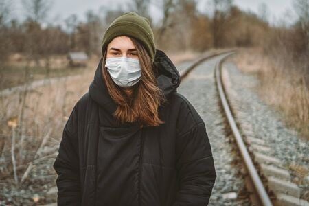 Portrait of young woman wearing medical mask, health protection from influenza virus, epidemic and infectious diseases. Protect your health. Coronavirus concept. Virus spread flu prevention carantine.の写真素材