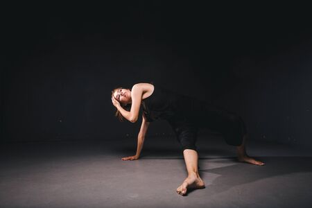 Portrait of a beautiful woman dancing on black background. Ballet and contemporary dancer dancing on...