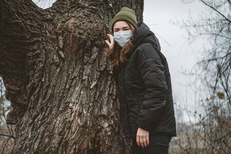 Human ecology mask, smog, pollution on planet. Pandemic flu. Health and safety concept, coronavirus N1H1, virus protection. Health and safety concept. apocalypse of humanity. Woman in protective mask.の写真素材