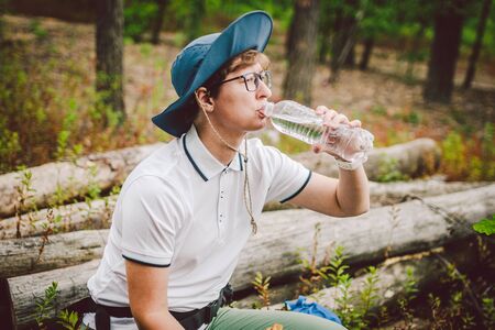 Woman eating lunch taking a break hiking. Hiker eating sandwiches in nature. Tourist stopped for...