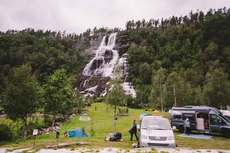 Tvinde Camping tents on the background of a waterfall Tvindefossen in Norway near Voss. Campsite in the norwegian fjords.のeditorial素材