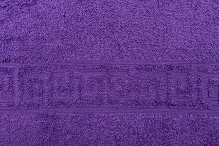 Terry towel, texture, textile background close up. Terry purple towel background. Color purple terry towel made of cotton fabric. Structure with uncut thread loops. purple towel background.の写真素材