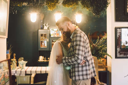 The first meeting of the newlyweds indoors. First look of the bride and groom in the morning. Love and happiness holiday wedding theme. Bride and groom meet for the first time. First Look Moment.の写真素材
