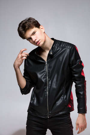 Handsome serious beauty male model portrait wear leather jacket. Man with attitude in leather jacket...