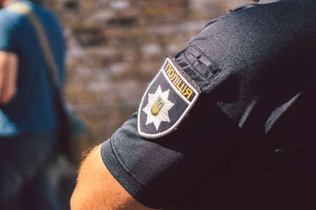 Police of Ukraine, badge of Ukrainian police close up. Police patrol Ukraine. Kiev. Chevron on the sleeve of a patrol policeman in Ukraine.の写真素材