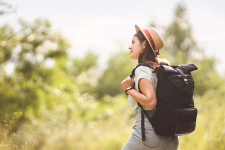 Young travel girl at viewpoint. Hipster girl with backpack. Travel concept. Beautiful woman hiker...