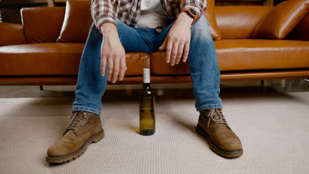 Alcohol addiction at young age. Caucasian male cannot stop drinking alcohol, drunken lonely male...