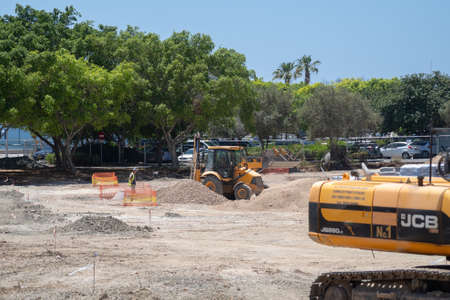 May 11, 2021 Cyprus, Paphos. Construction work with construction equipment and road renovation...
