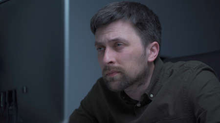 Tired male working on computer. Sad exhausted man at home office. Stressful work, stress at...