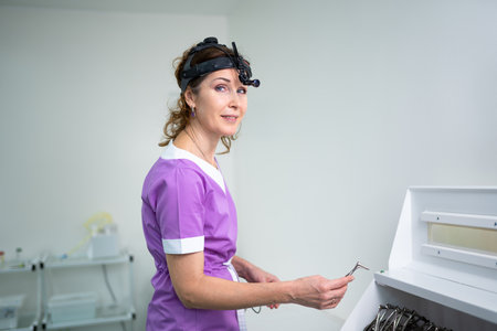 Professional otolaryngologist in modern clinic. Portrait of woman otolaryngologist or audiologist. Healthcare occupations. ENT doctor. Otolaryngology specialist posing in clinic.の写真素材