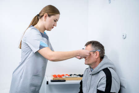 Male patient undergoes an eye test and prescription for eyeglasses in ophthalmology clinic....