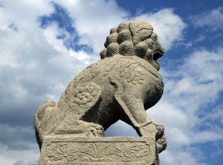 Stone lion sculpture on clouds bacgroundの写真素材