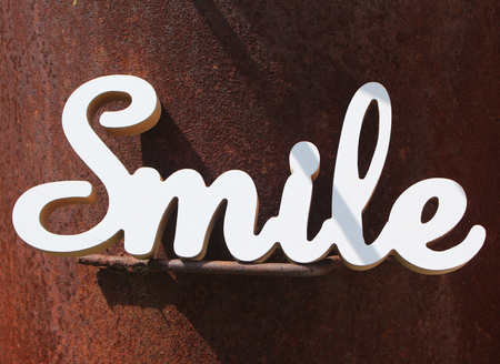 positive smile text on rusty iron backgroundの写真素材
