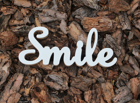 3d white text smile on wood bark backgroundの写真素材
