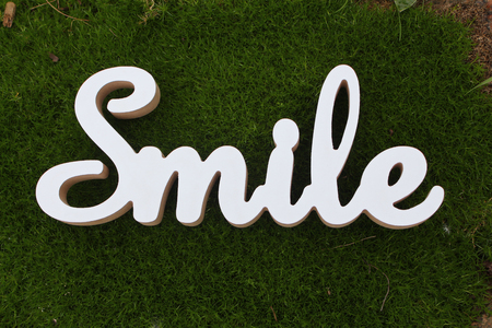 3d white text smile on green grass backgroundの写真素材