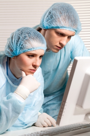 Two doctors in the office computer diagnosisの写真素材