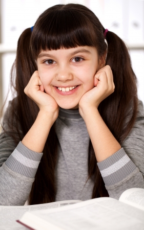 portrait of a smiling girl with a bookの写真素材