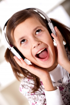 the girl is singing loudly in the headphonesの写真素材