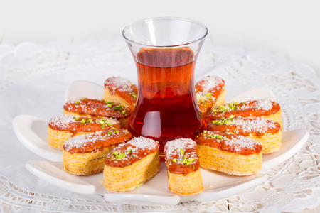 Light Crunchy Puff Layered Pastry Garnished With Pistachios & Coconut Flakes And Cup Of Tea Popular...